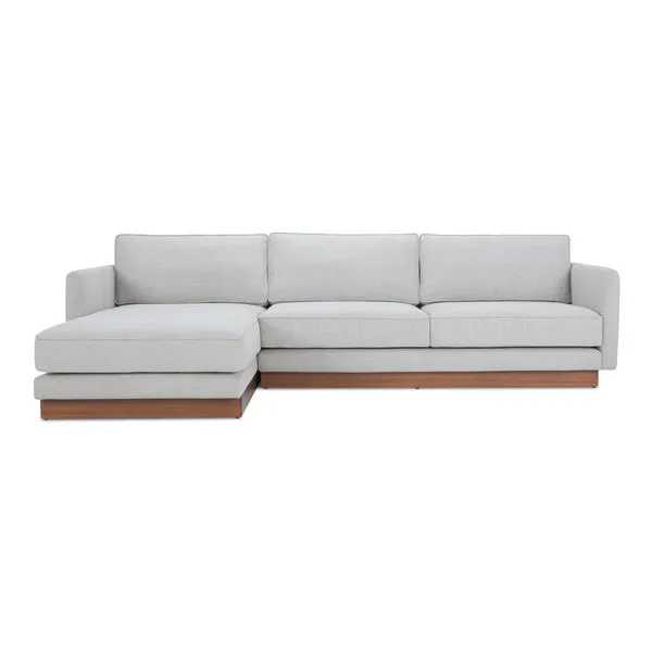 Light gray Vernon sectional sofa with wooden plinth base and reversible cushions, left-facing chaise