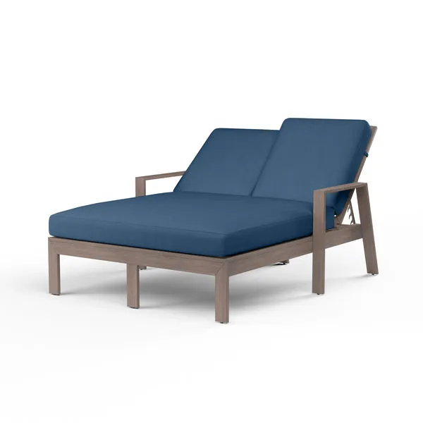 Laguna Double Chaise Lounge with hand-brushed driftwood finish aluminum frame and deep blue cushions