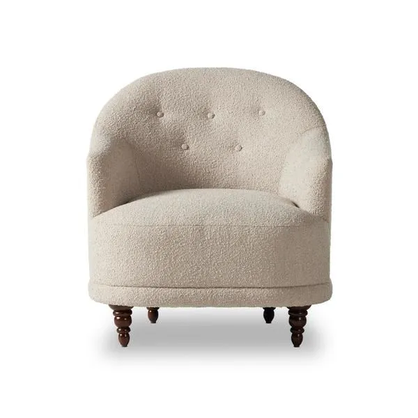 Front view of Marnie Chair highlighting its tufted backrest and rounded shape