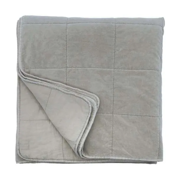 Folded Amsterdam Coverlet showing reversed side and quilted edges in shore blue cotton