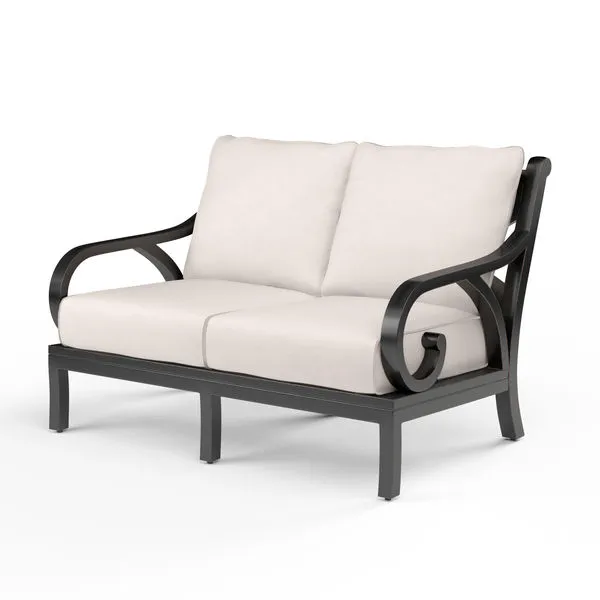 Monterey Loveseat with Espresso aluminum frame and cream cushions, featuring curved armrests and a stately outdoor design