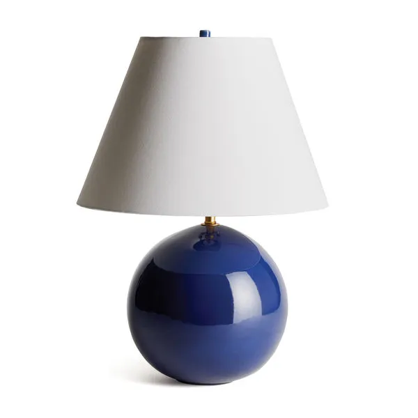 Table lamp with a deep blue high gloss rounded ceramic base and bright white tapered fabric shade