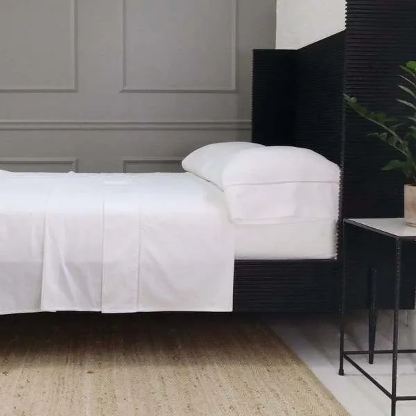 White Como Ladder Stitch Cotton Sateen pillowcases on bed with subtle ladder stitch detailing