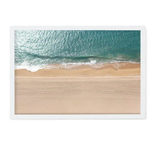 Aerial ocean view photography with turquoise water and sandy beach in a sleek white frame